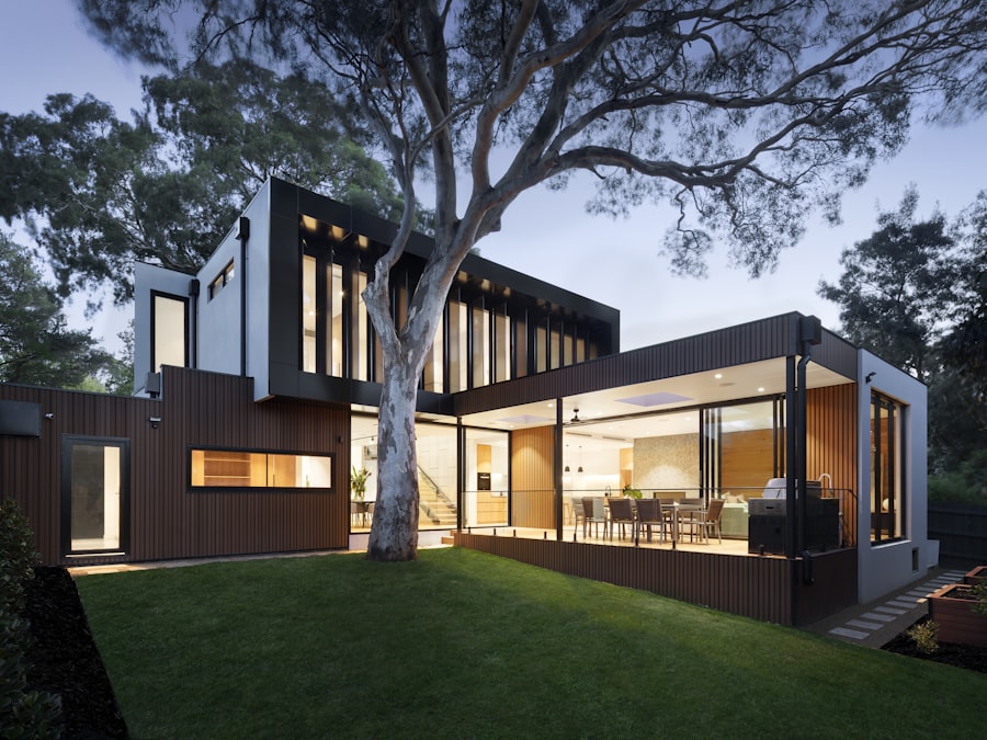 Modern timber-clad house lit up at dusk, a strong exterior opening shot for a home tour reel