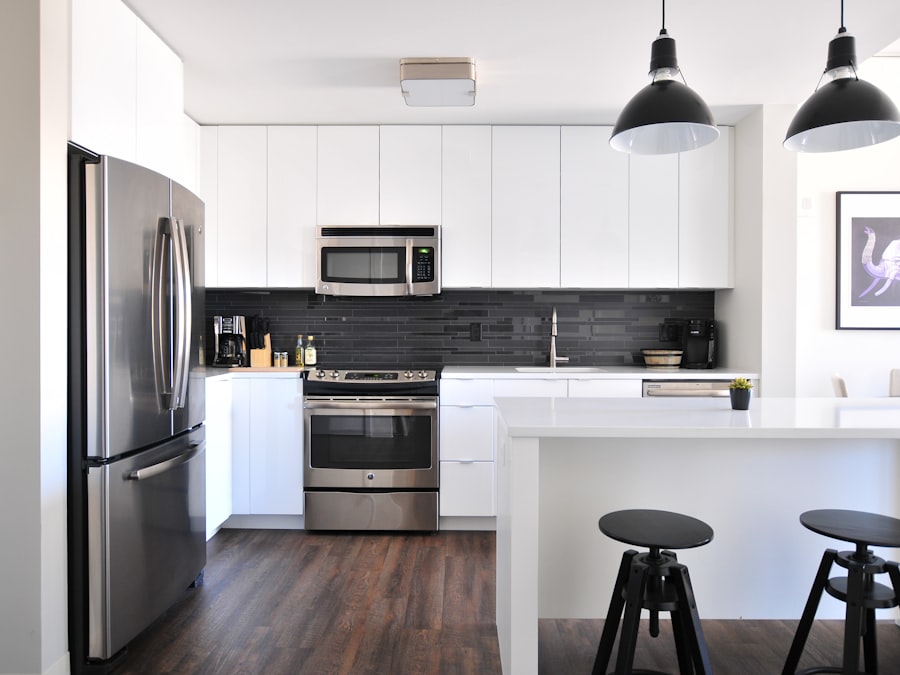 Bright modern kitchen with a white island, pendant lights and bar stools