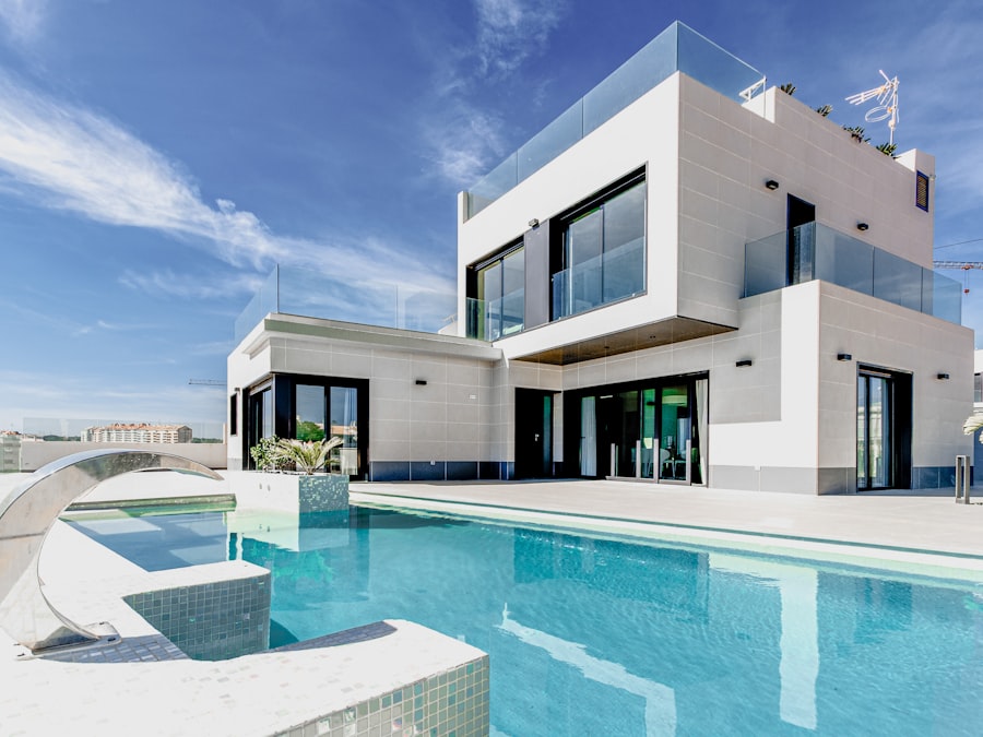 Modern home exterior with a swimming pool and clear blue sky, an aspirational outdoor space shot